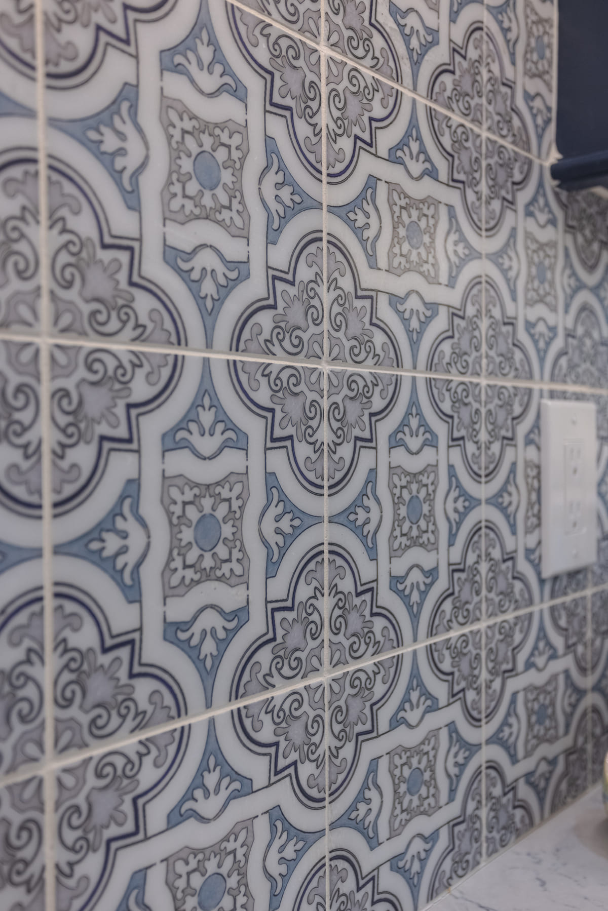 Blue and black mosaic tile detail by Legacy Builders Group