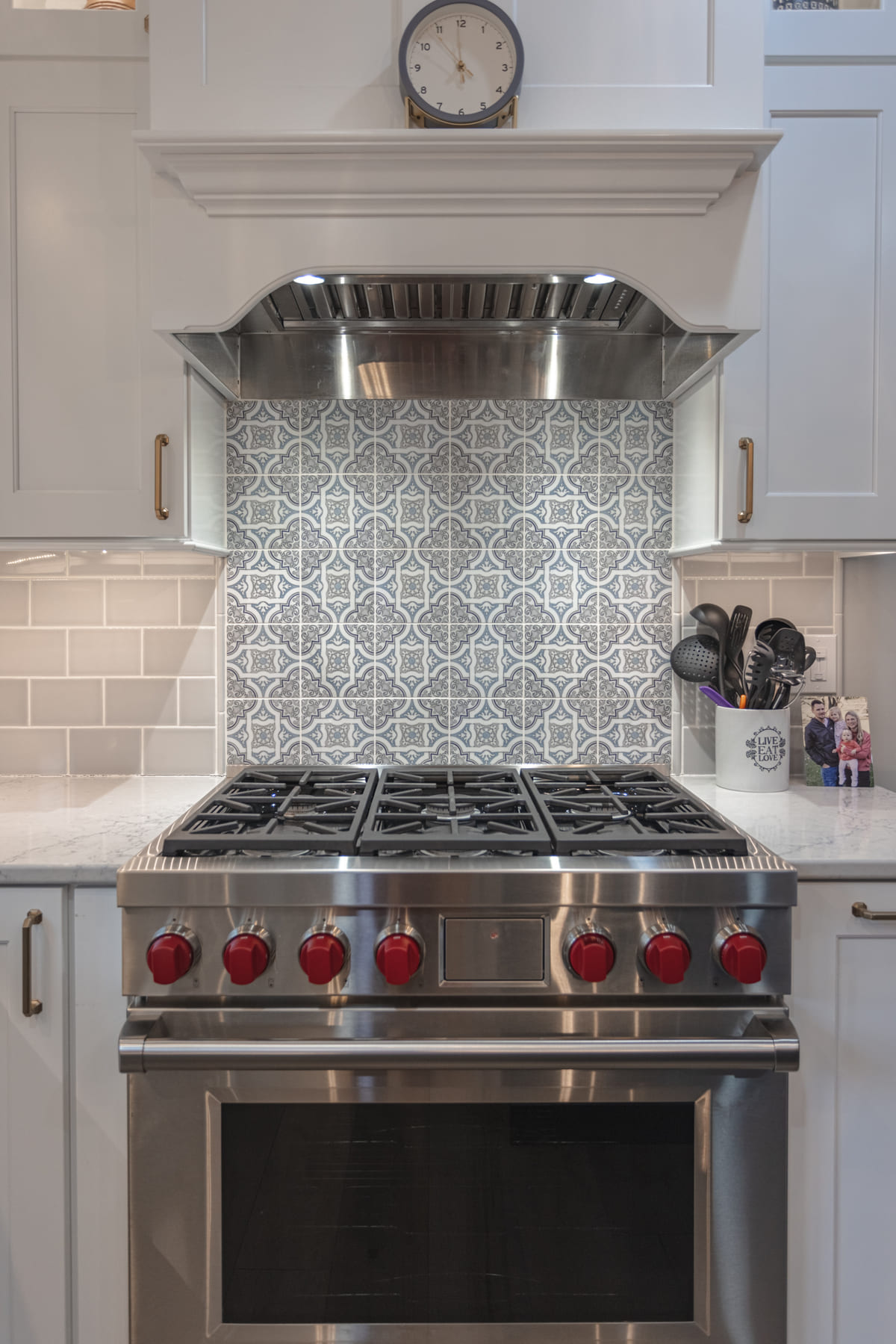 Custom range hood with mosaic tile backsplash behind in Cincinnati, OH kitchen remodel