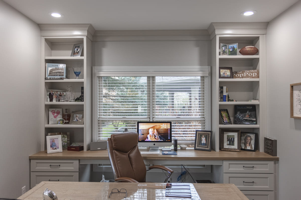 Modern home office remodel with built-in shelving and desk