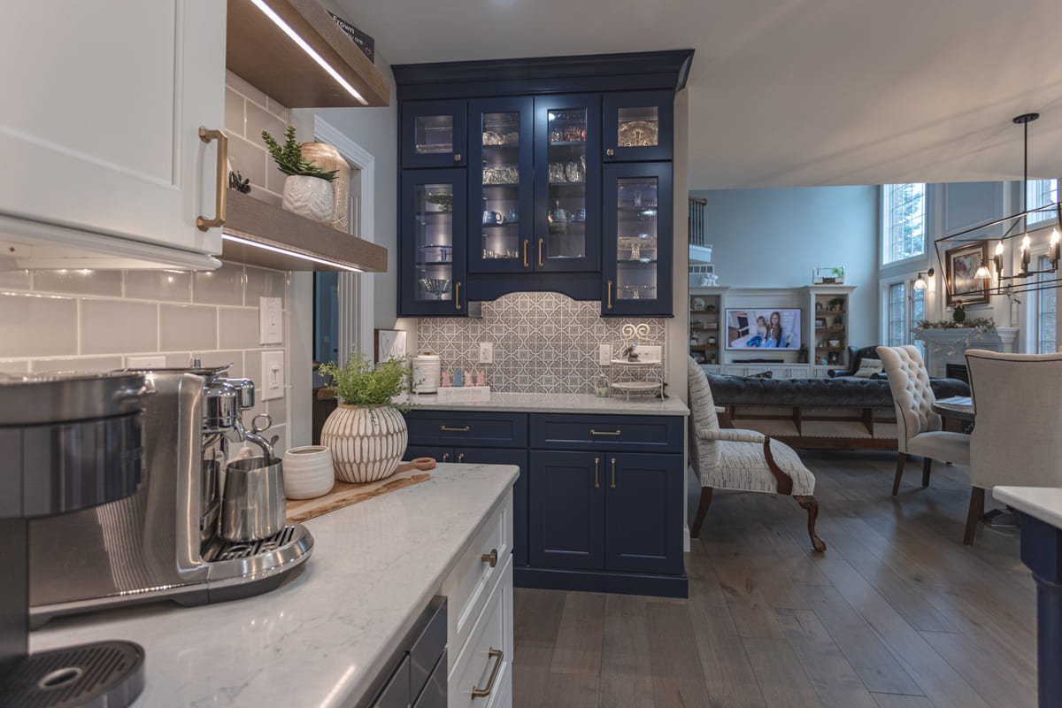 Two-tone aesthetic kitchen remodel with white cabinets and blue cabinets on dessert center