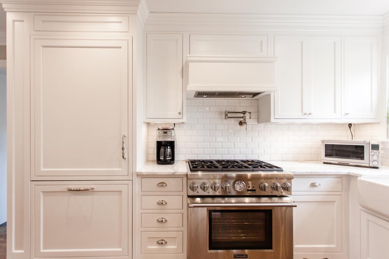White kitchen remodel in Cincinnati, OH with white subway tile backsplash and paneled refrigerator cabinetry