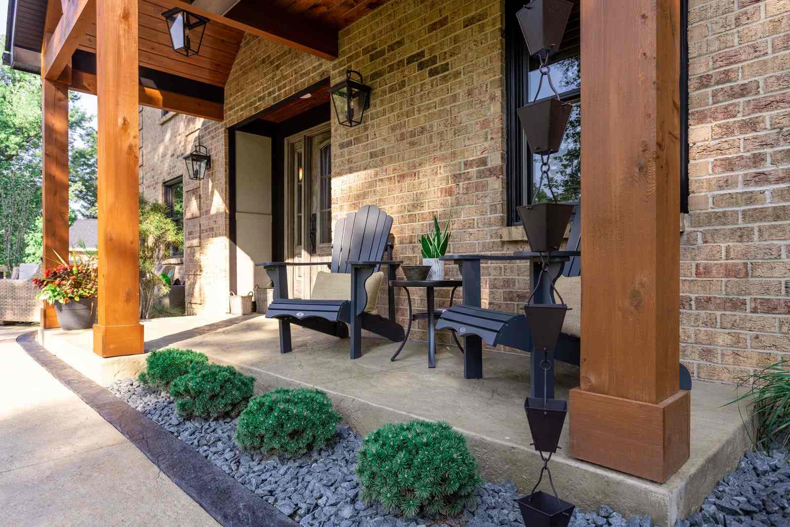 Front porch with cedar wood columns and two chairs