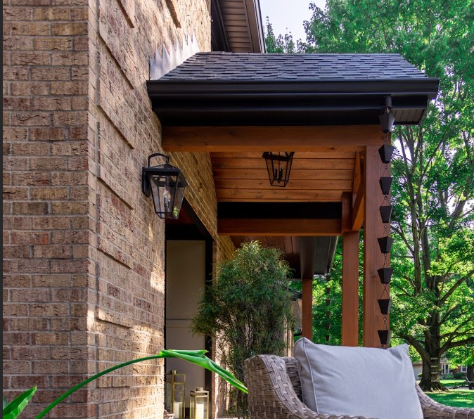 Side view of porch roof with outdoor light sconces