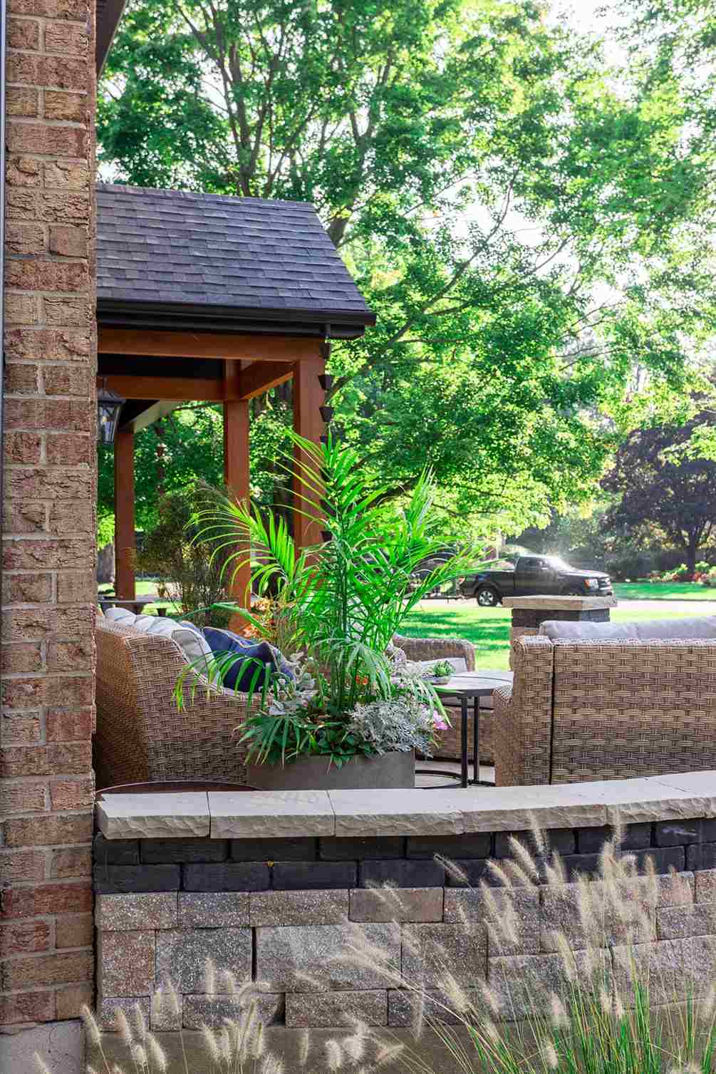 Stacked stone patio seating wall with fern plant