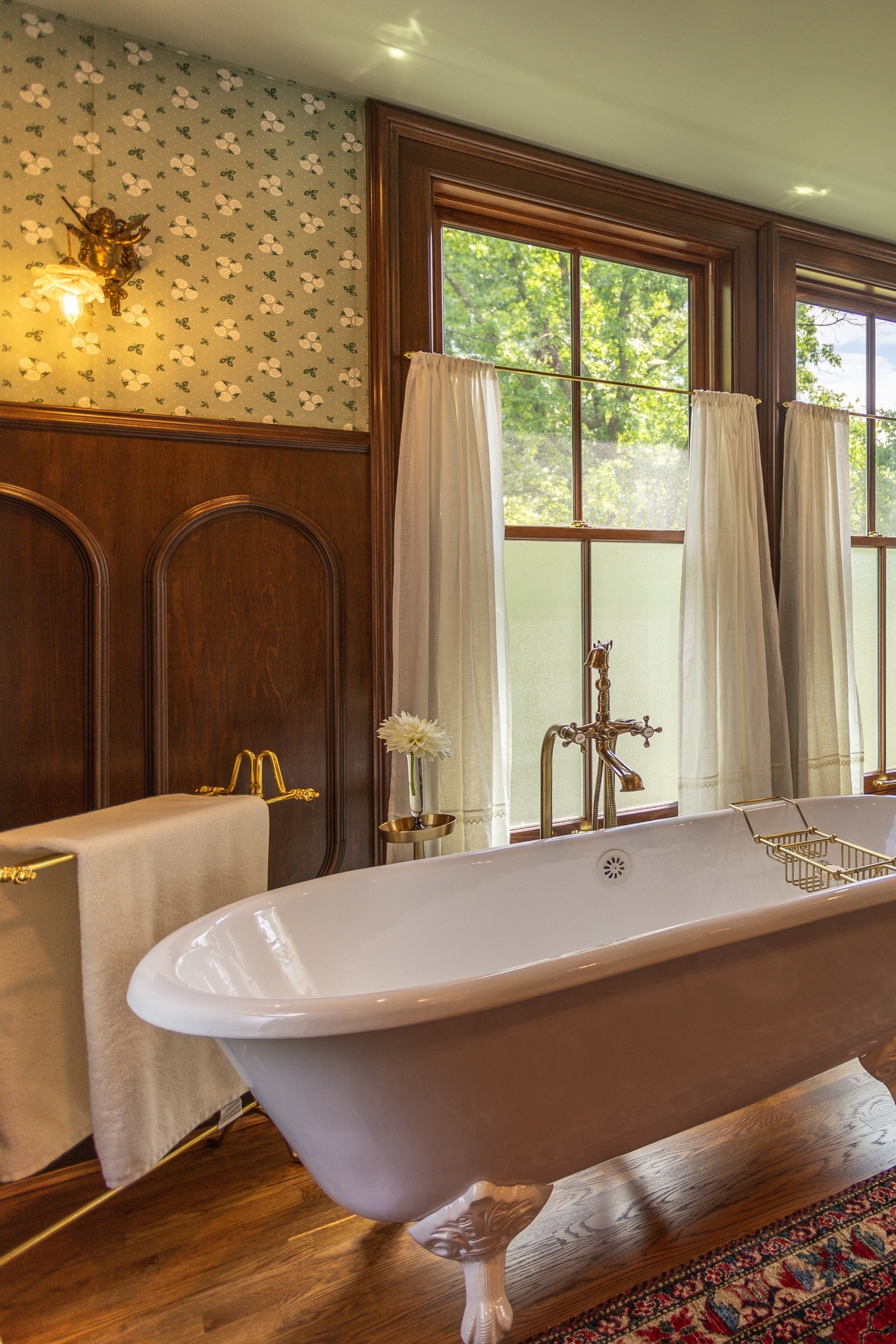 Historic bathroom remodel in Cincinnati area with freestanding tub and brass fixtures