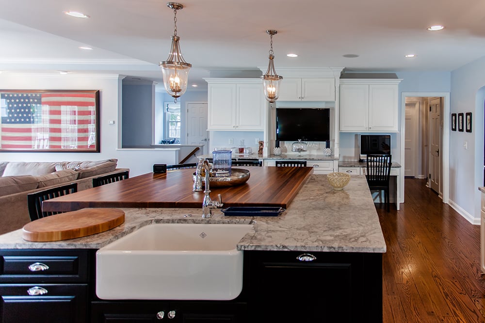 Spacious kitchen home addition with marble countertops, farmhouse sink, and hardwood floors located in Cincinnati