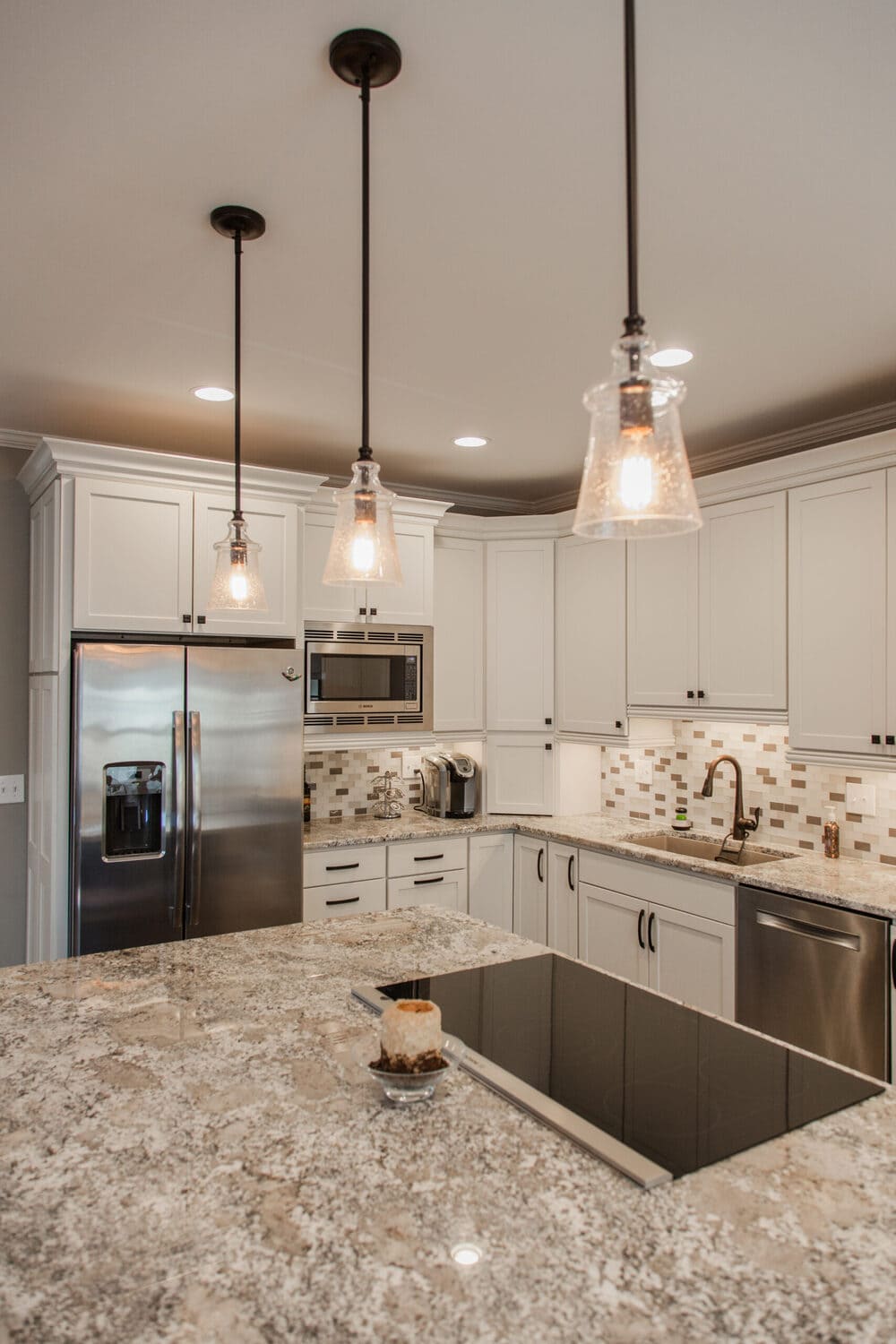 Custom kitchen remodel with white shaker cabinets and large island