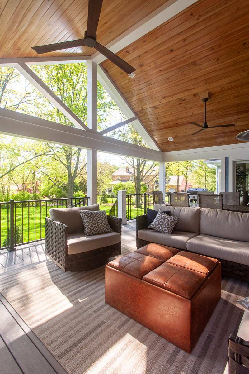 Modern outdoor living space with vaulted wood ceilings in backyard