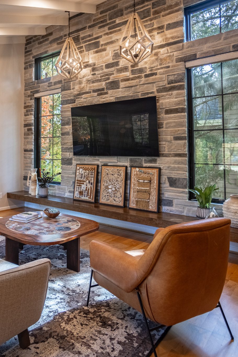 Mounted TV on stone accent wall with floating bench in Evendale, OH great room addition