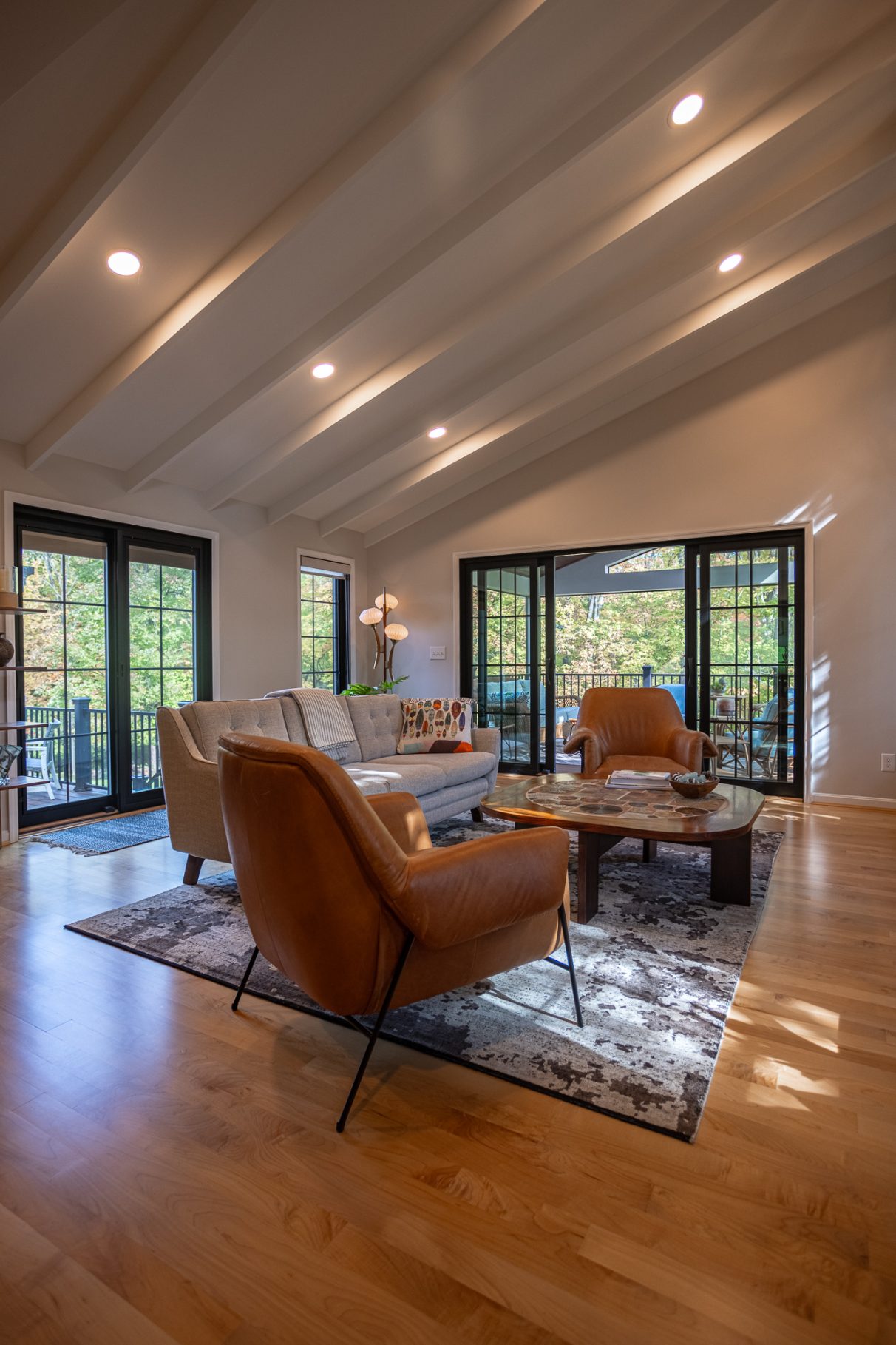 Open-concept great room addition in Evendale, Ohio by Legacy Builders with sliding doors to outside