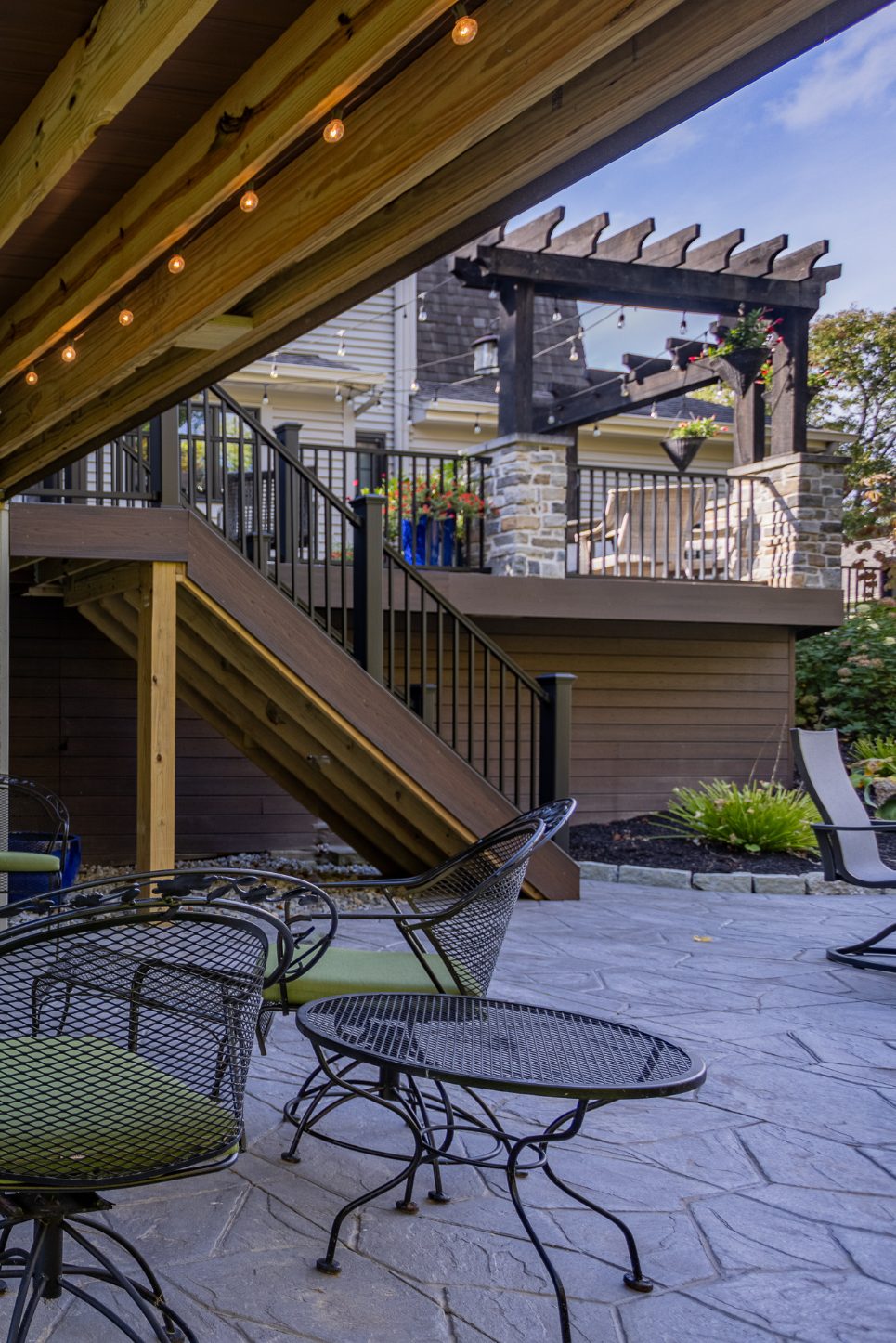 Steps down to outdoor living space with stamped concrete by Legacy Builders in Evendale, Ohio