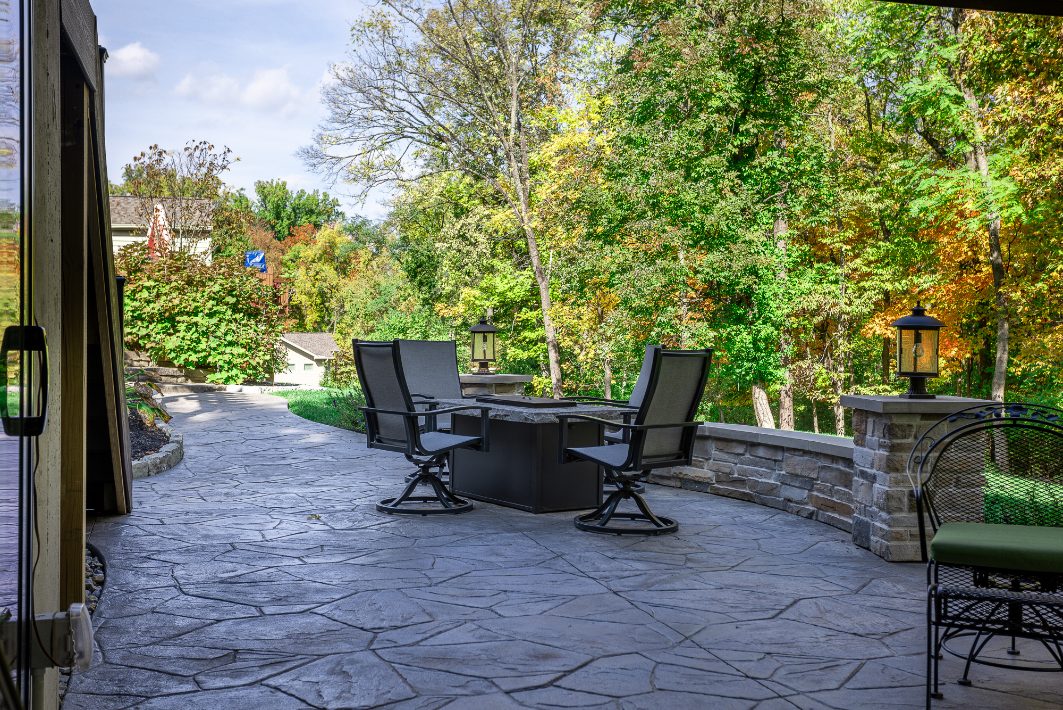 Three chairs around fire pit in Evendale, OH outdoor living space by Legacy Builders 
