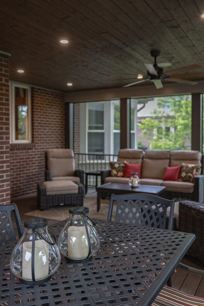 Covered deck seating area with wicker furniture, wood ceiling, screened walls, and dining space. Covered deck seating area with wicker furniture, wood ceiling, screened walls, and dining space.